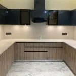 Real installed U-shaped wooden and black modular kitchen
