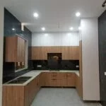 Real installed dark wood U-shaped modular kitchen